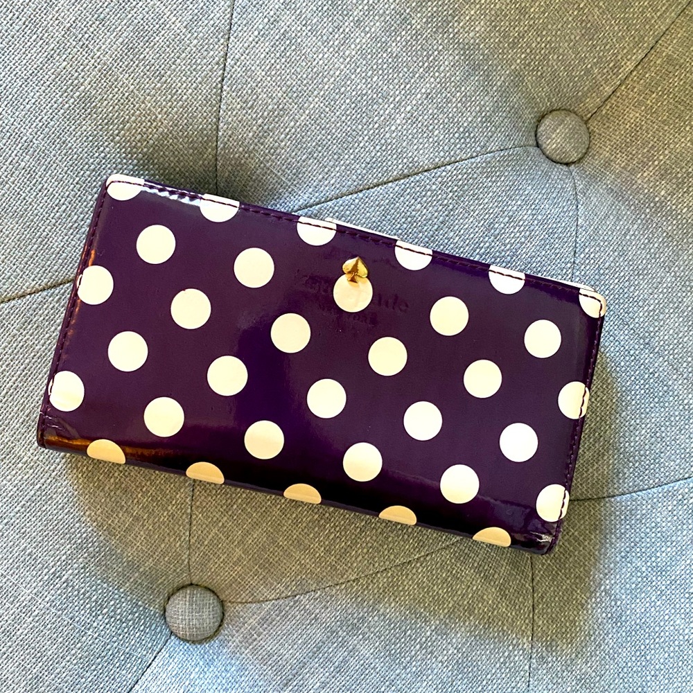 Kate Spade plum wallet with cream polka dots and inside.